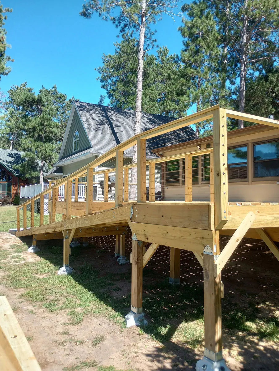 New raised deck with cable railing and a long ramp