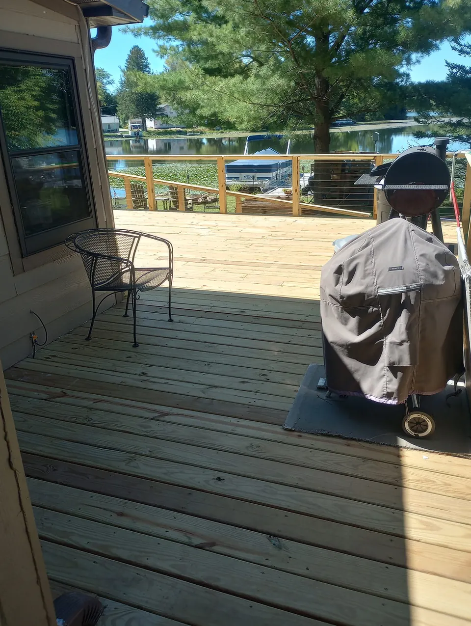 Deck boards and railing looking out toward the lake