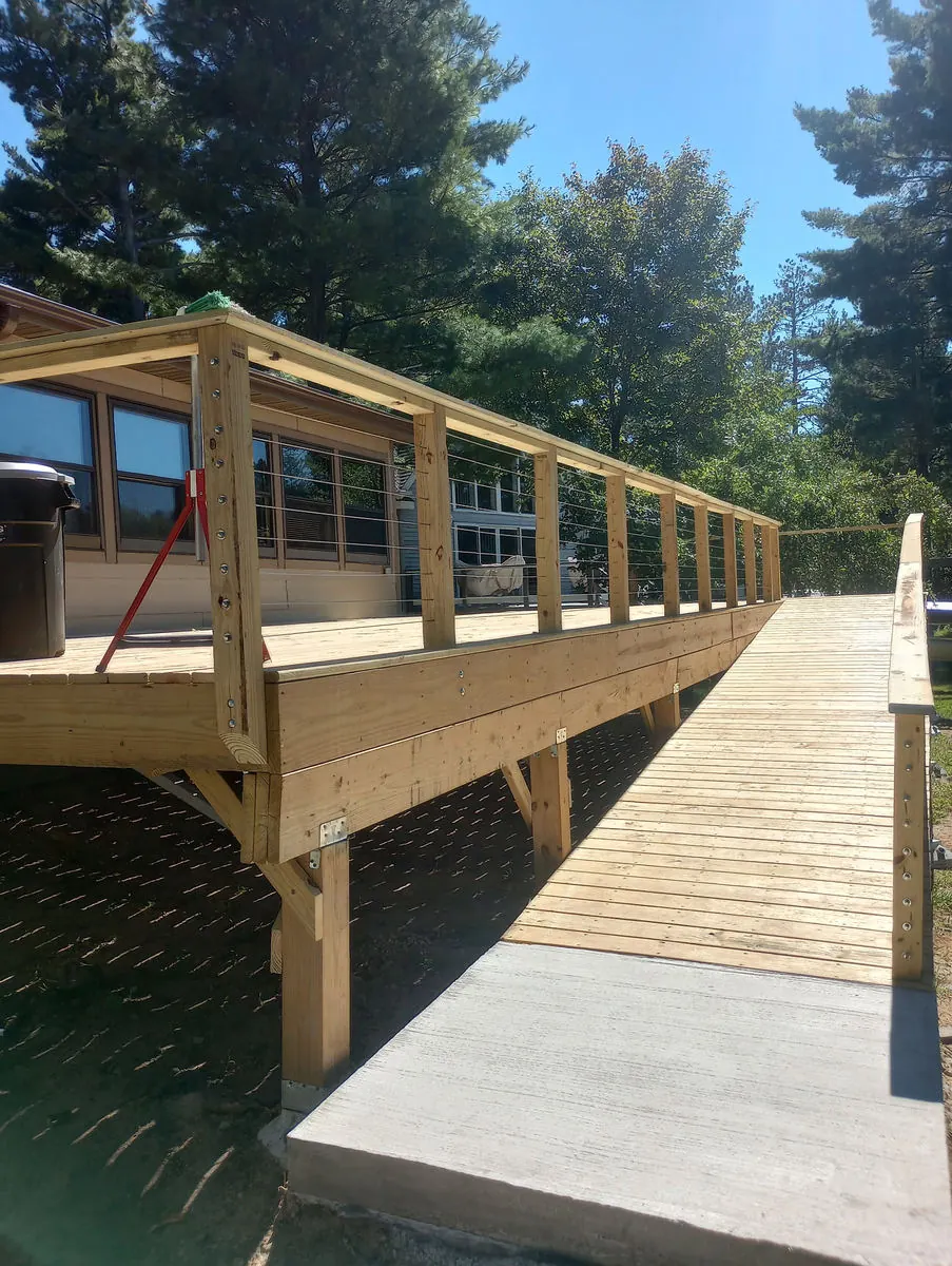 Deck ramp landing on a concrete pad