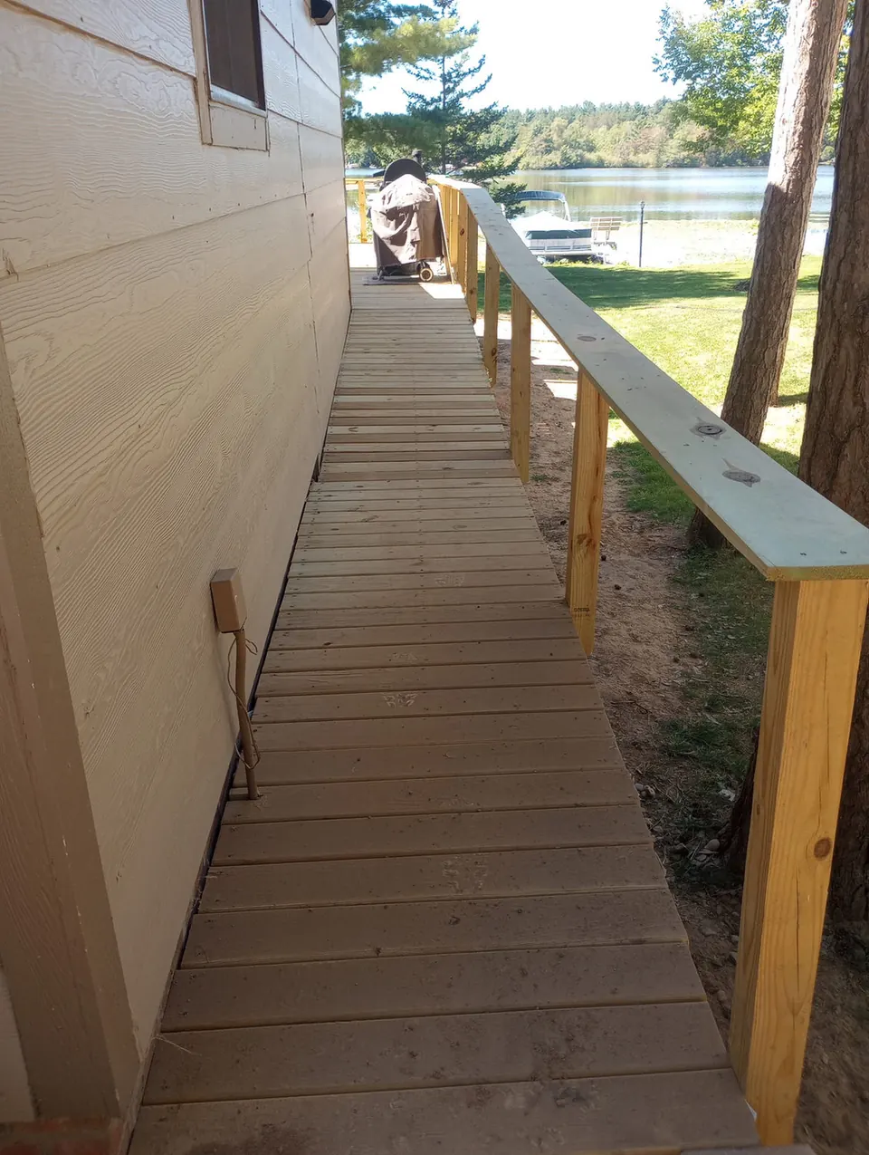 Wooden ramp walkway running along the side of a house