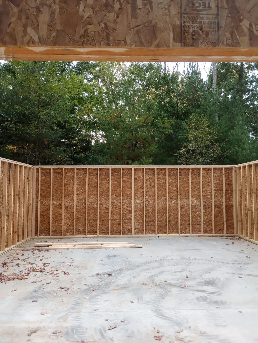 Framed garage walls standing on a new concrete slab