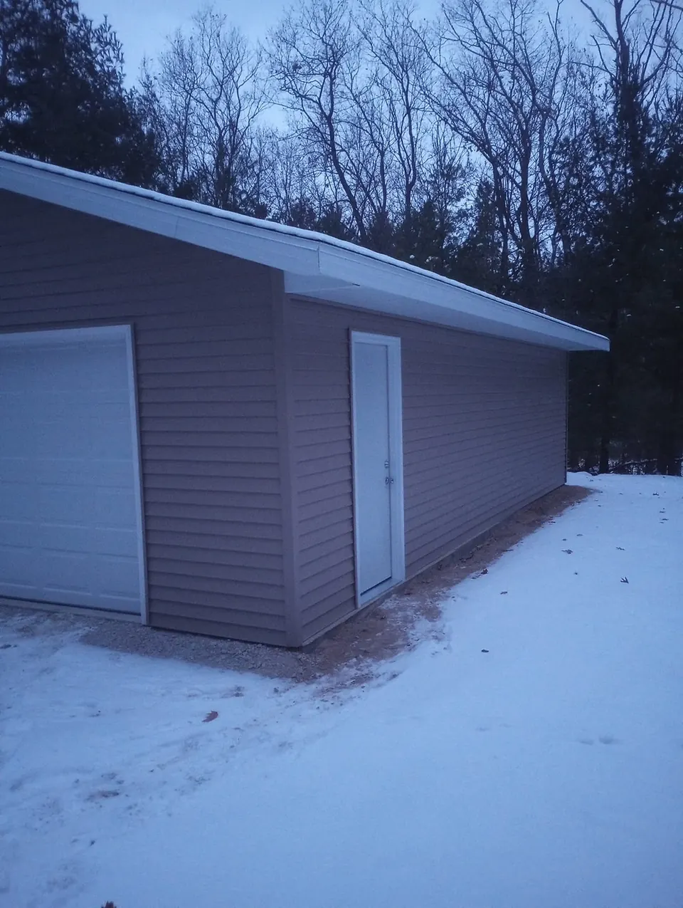 Side view of a finished garage in winter